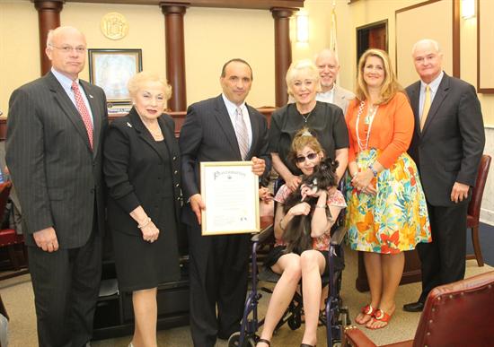 The Monmouth County Board of Chosen Freeholders present a proclamation for Dystonia awareness to Joanna Nachbar of Freehold and her parents Len and Janice on May 23.
